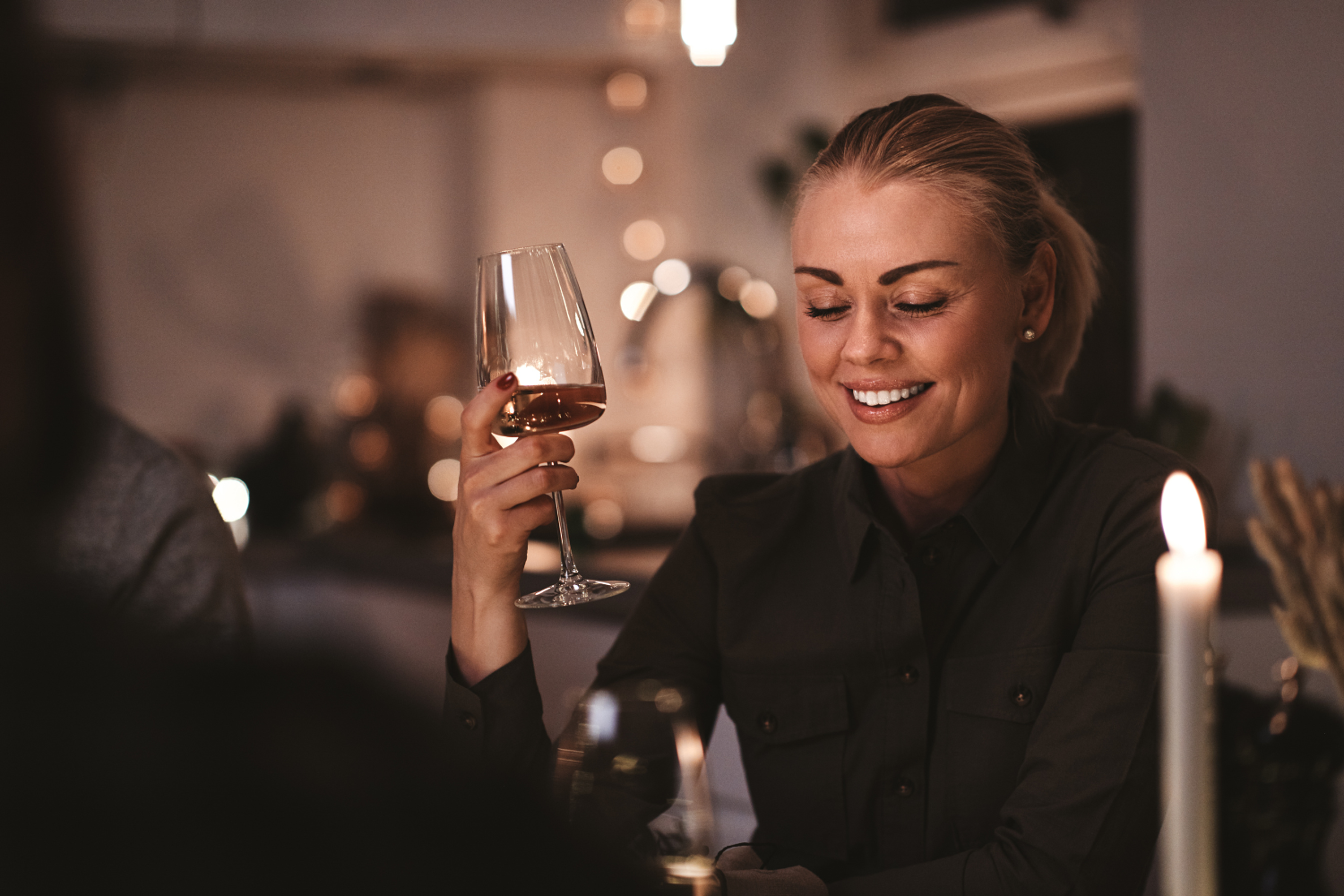 Woman holding a glass of wine during dinner