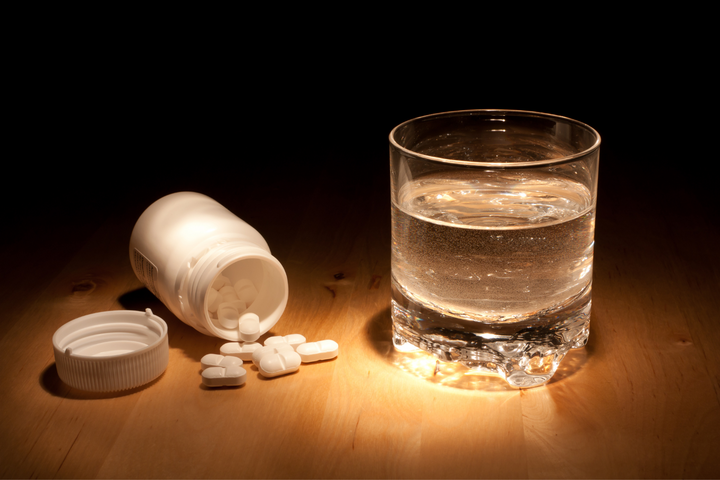 Tablets and a glass of water
