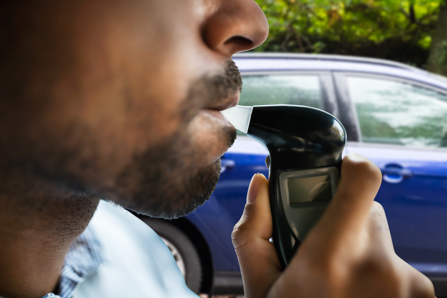 Man taking a breathalyzer test.