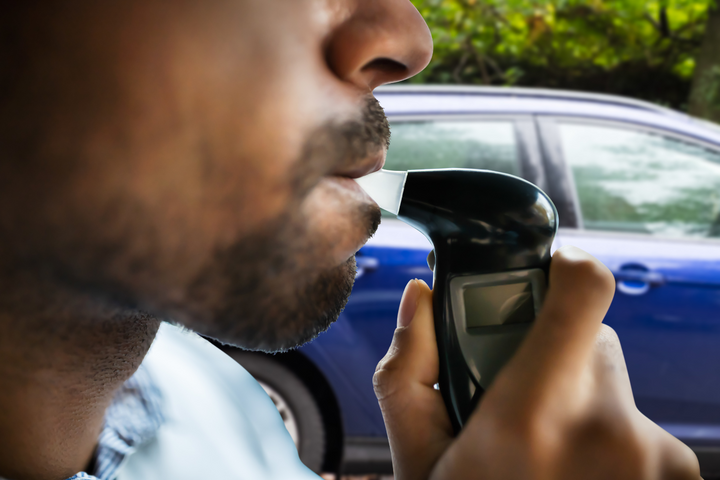 Man taking a breathalyzer test.
