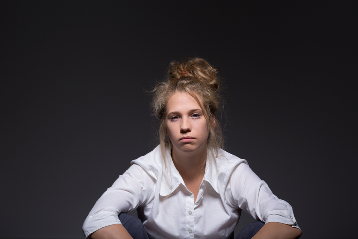 Woman with a tired and low-energy expression, symbolizing the emotional and mental exhaustion that accompanies sobriety fatigue and low motivation.